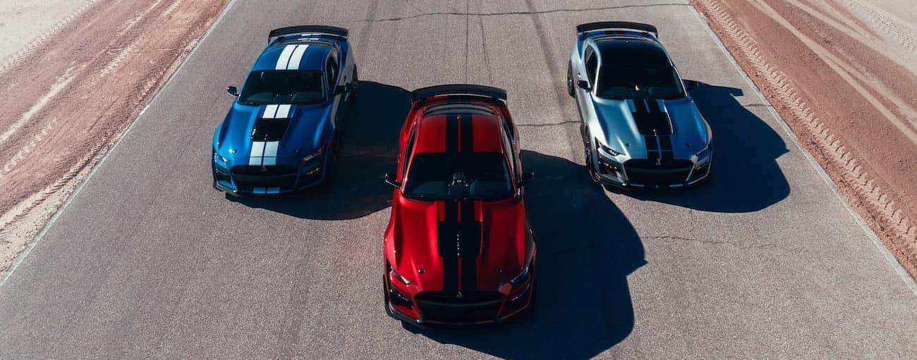 Three 2020 Shelby GT500s in grey, red, and blue are racing near Cincinnati, OH.