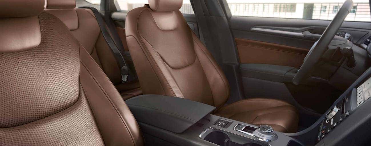 The brown and black leather front interior of a 2019 Ford Fusion.
