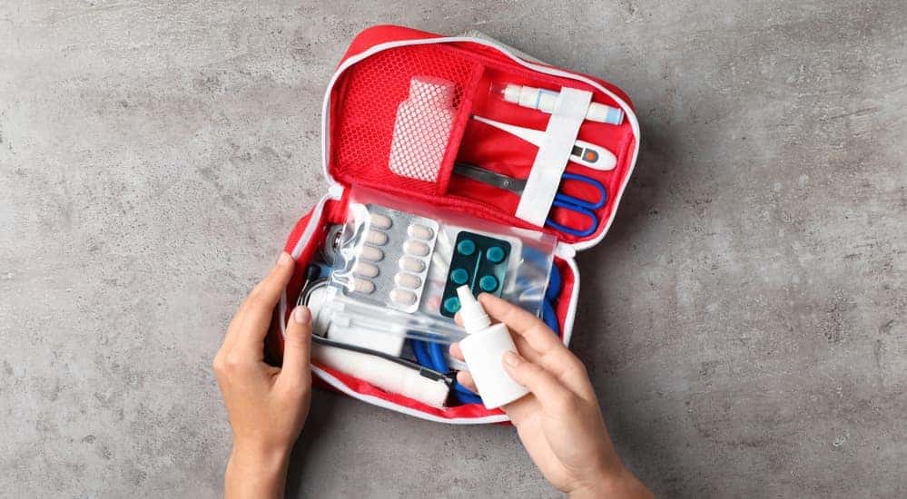 A woman is looking at the best first aid kit medications and medical treatments that she has.