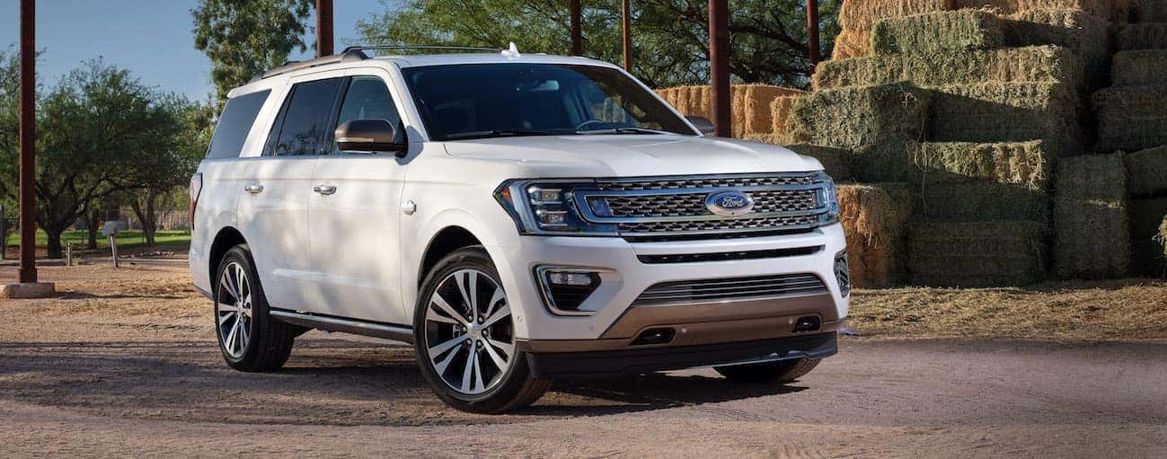 A white 2020 Ford Expedition is parked on a road next to bails of hay near Cincinnati, OH.