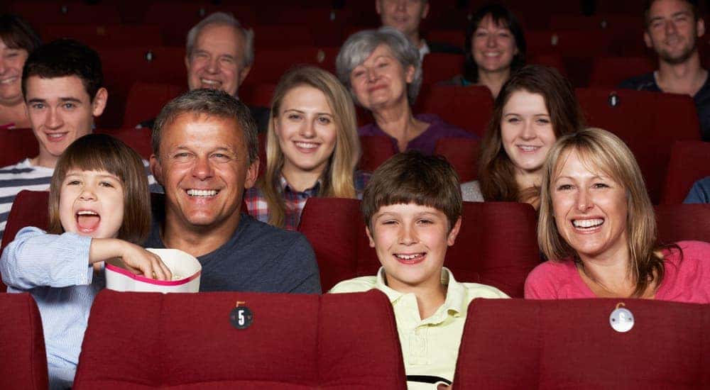 A family is sitting in the audience laughing.