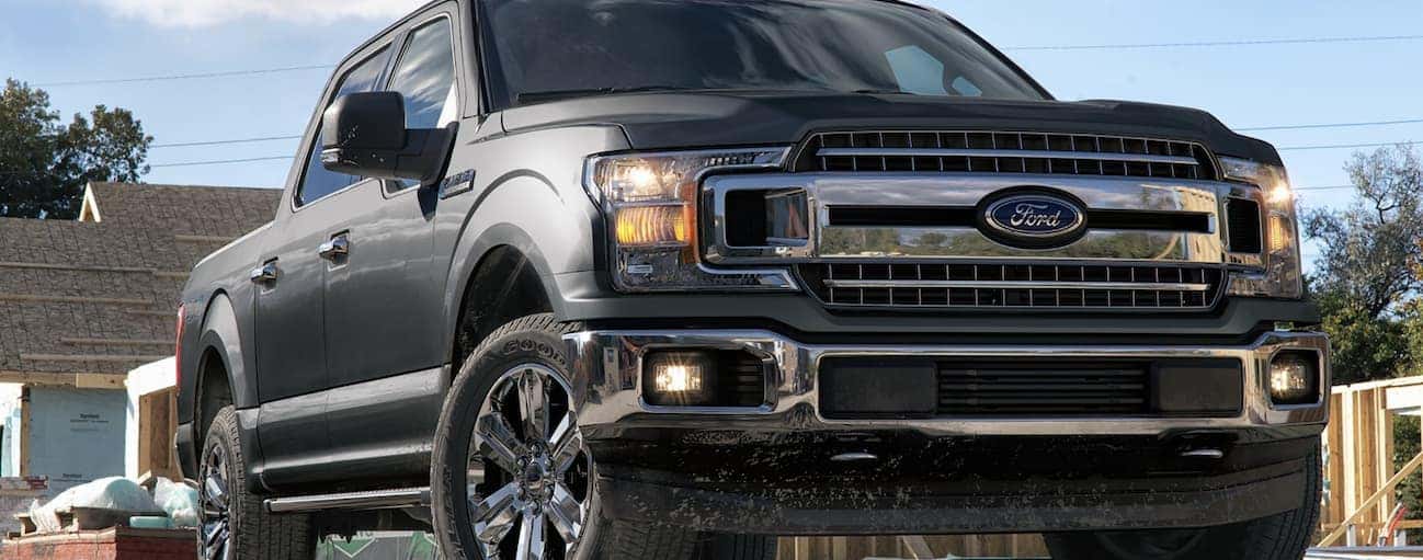 A grey 2020 Ford F-150, which wins when comparing the 2020 Ford F-150 vs 2020 GMC Sierra 1500, is parked at a construction site near Cincinnati, OH.
