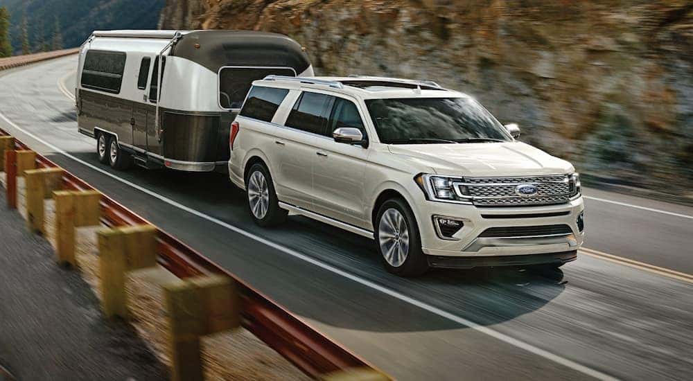 A white 2020 Ford Expedition. which is a popular option among Ford SUVs, is towing an Airstream on a rock hill road near Cincinnati, OH.