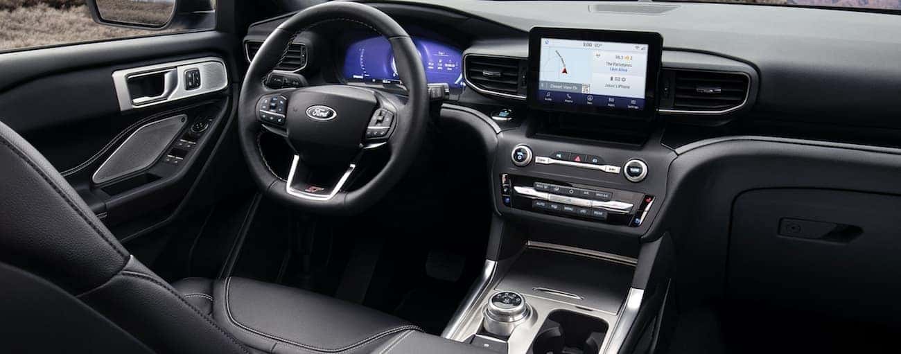 The front black leather interior of a 2020 Ford Explorer is shown. 
