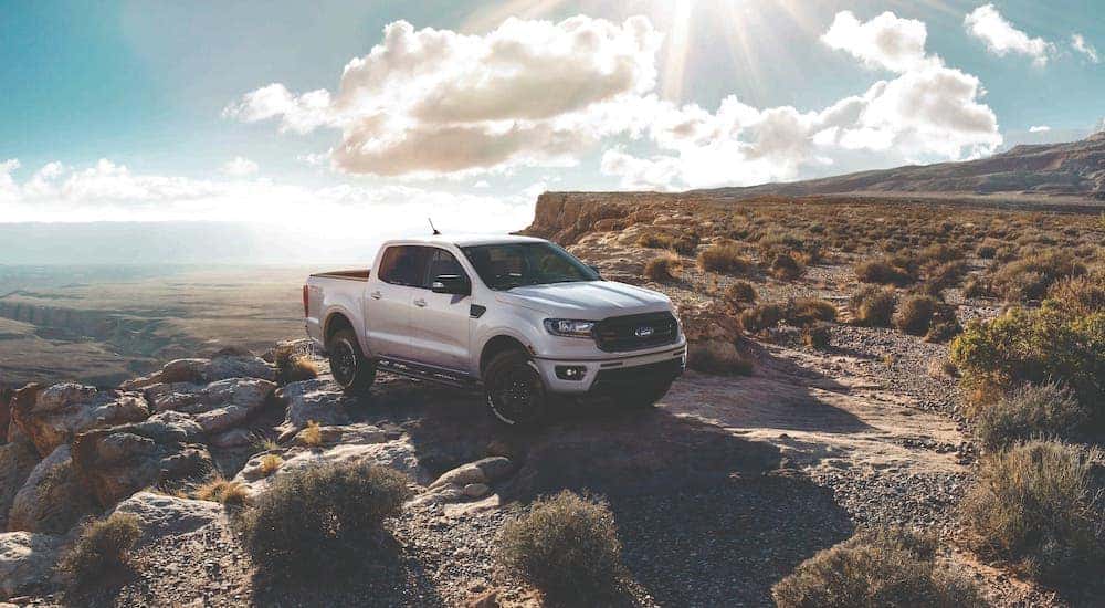 A popular used Ford Truck, a white 2019 Ranger is parked on a cliff edge.