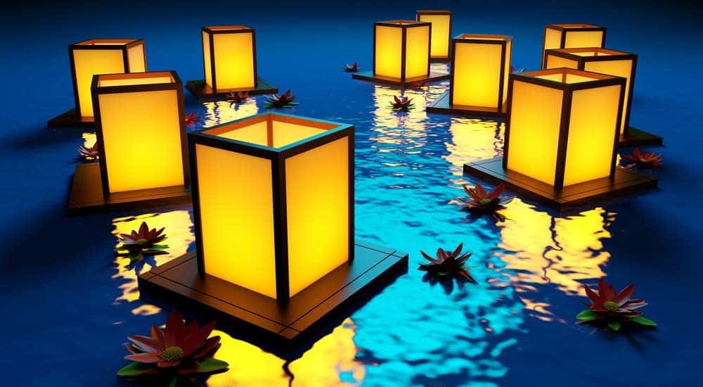 Lanterns are floating in the water and glowing.