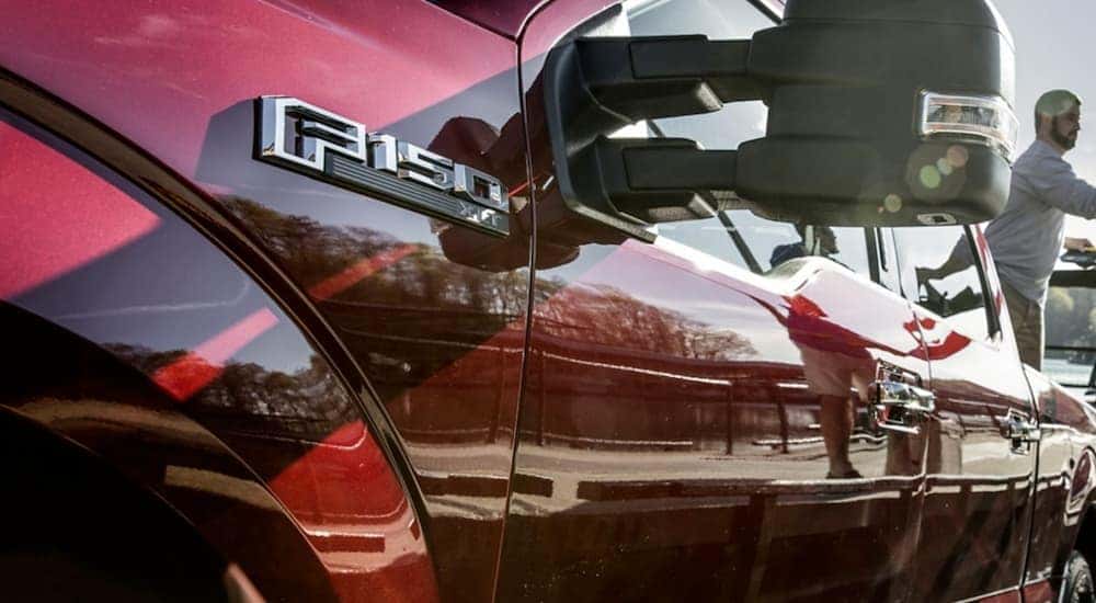 The side emblem on a red 2020 Ford F-150 is shown.