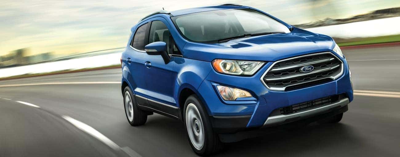 A blue 2020 Ford EcoSport is driving around a bay.