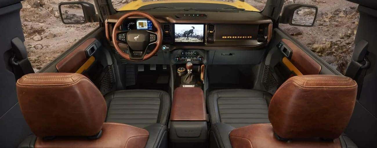 The brown and black interior of a 2021 Ford Bronco is shown.