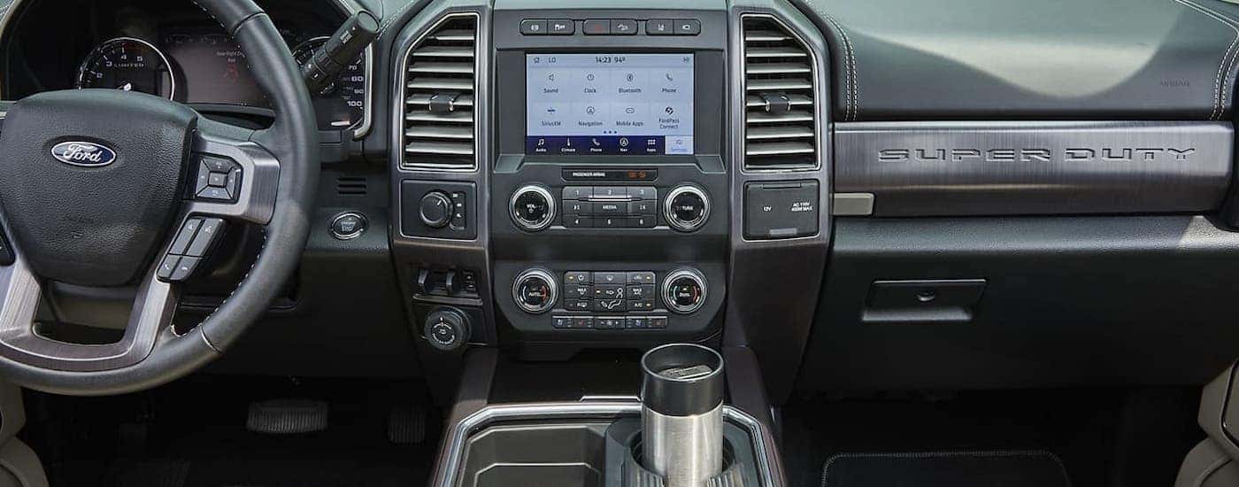 The infotainment screen and dashboard are shown inside a 2020 Ford F-250.