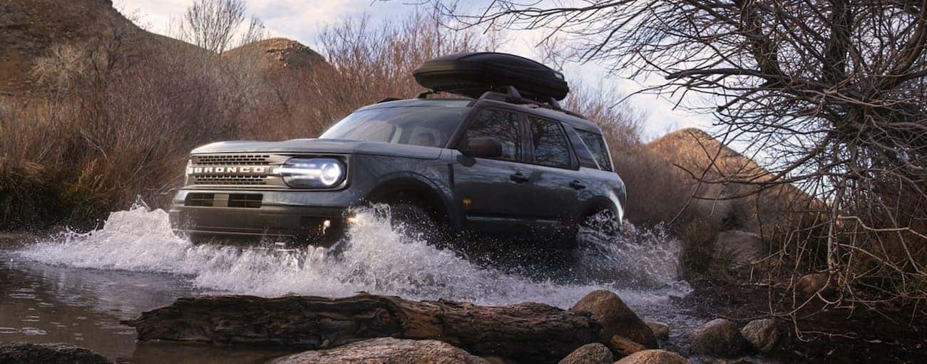 A grey 2021 Ford Bronco Sport is off-roading through a river outside of Cincinnati, OH.