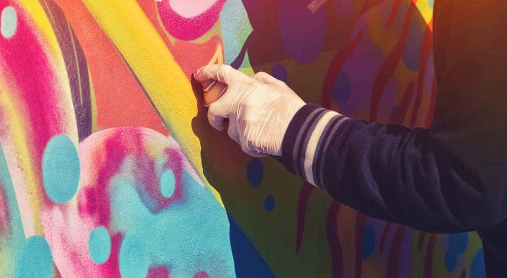 A street artist is painting with bright colors.