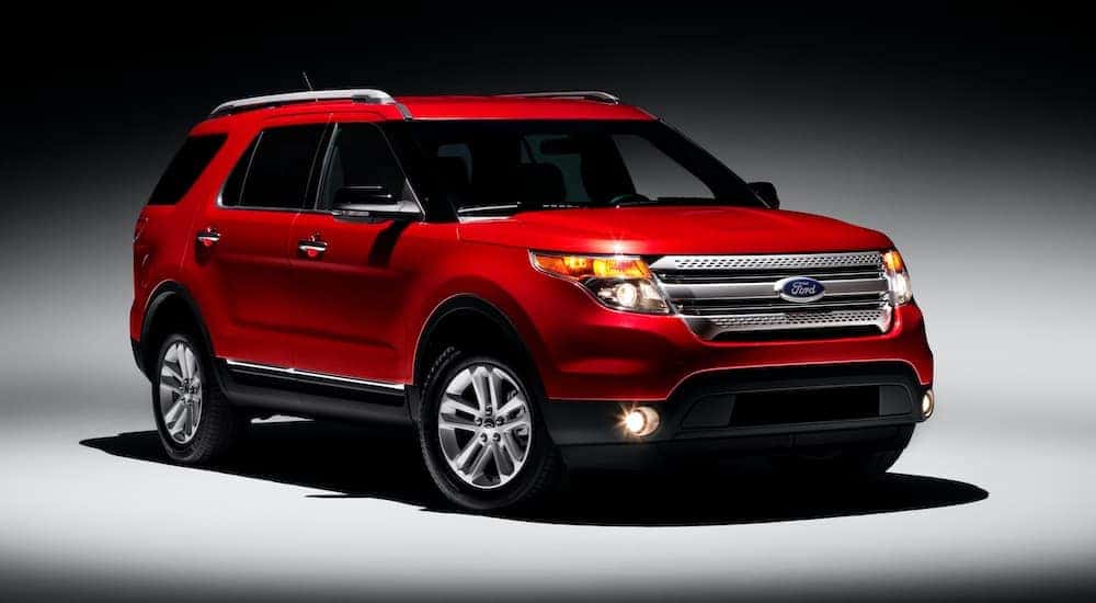 A red 2011 Ford Explorer is shown from the front, angled right.