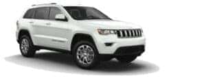 A white 2021 Jeep Grand Cherokee is angled right.
