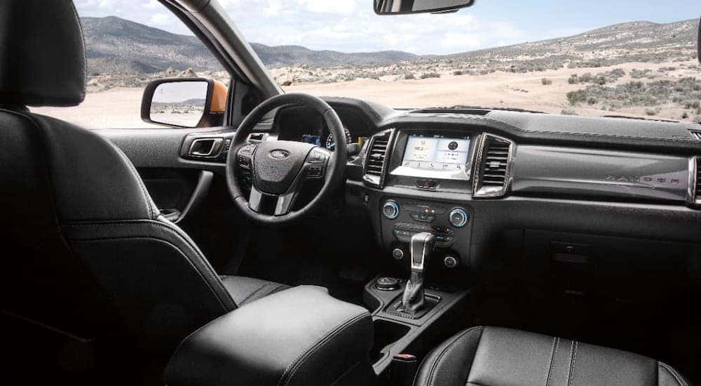 The black steering wheel and dashboard of a 2019 Ford Ranger are shown.