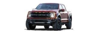 A red 2021 Ford F-150 Raptor is angled left.