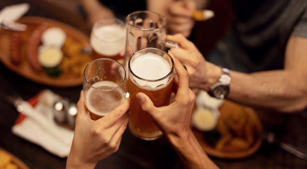 Friends are toasting with beers at a Cincinnati tavern.