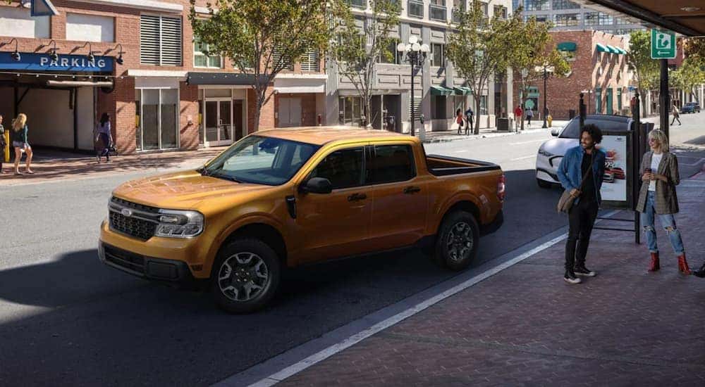 A yellow 2022 Ford Maverick is shown parked on a city street after leaving a Cincinnati Ford Maverick dealer.