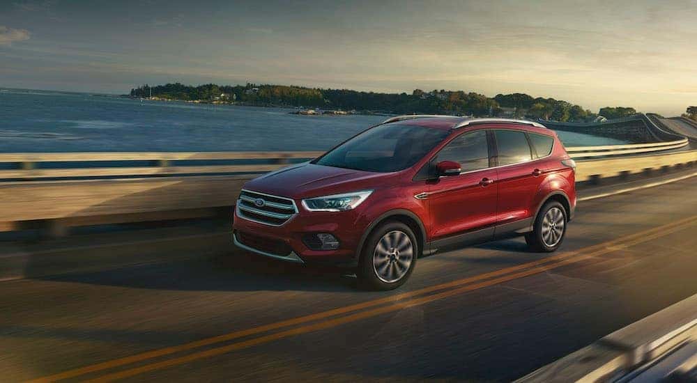 A red 2017 Ford Escape is shown driving after looking at Cincinnati used cars.