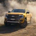 A yellow 2023 Ford Ranger Wildtrak is shown kicking up dust after visiting one of the most popular Ford dealers in Cincinnati.