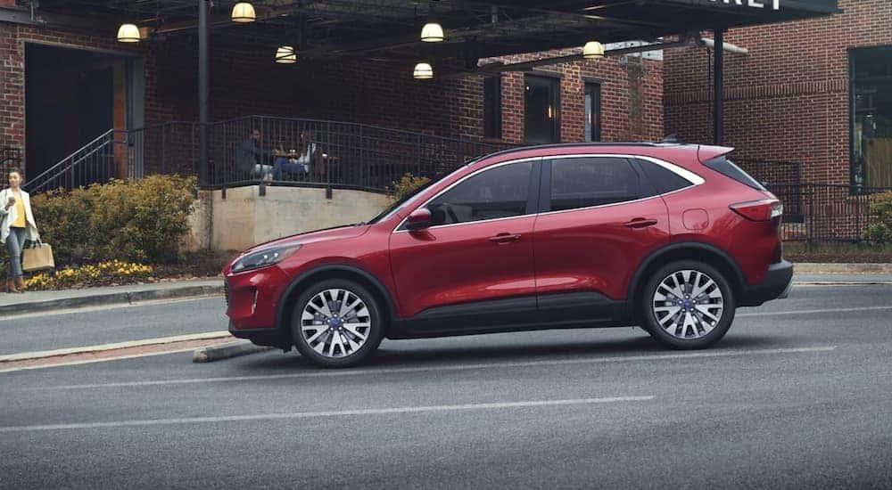 A red 2022 Ford Escape is shown from the side parked in front of a brick building.