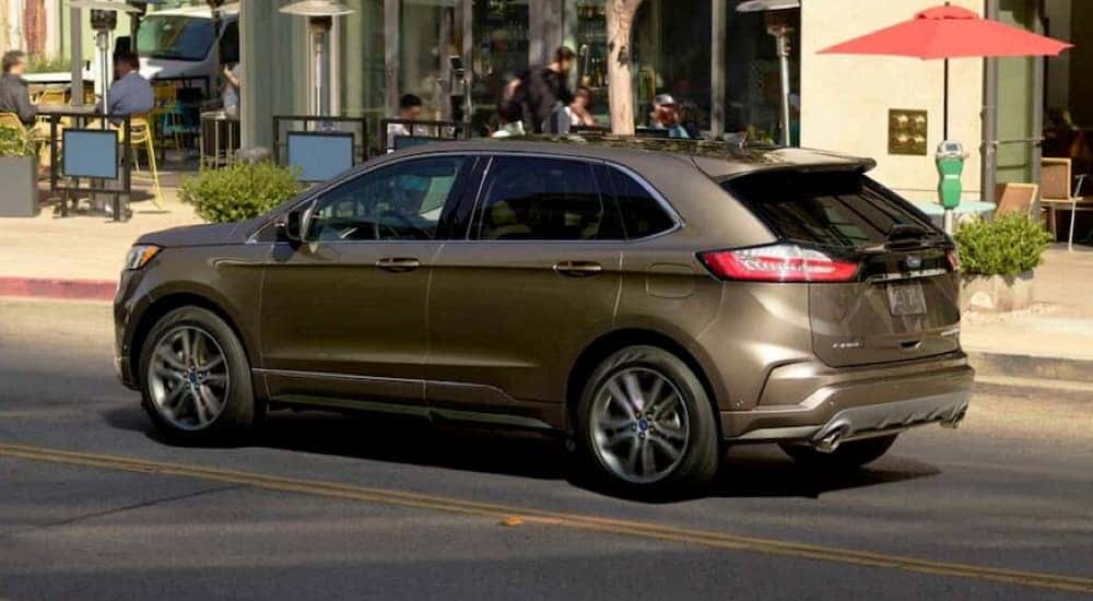 A brown 2019 Ford Edge is shown parked on the side of a city street.