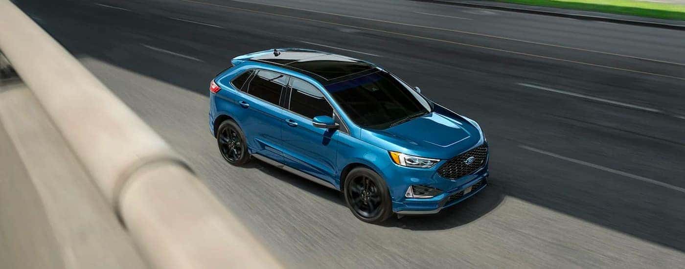 Overhead view of a blue 2020 Ford Edge ST on a highway.