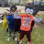 two children dressed as superheroes