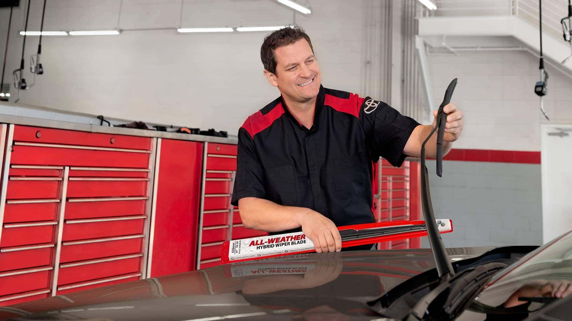 service tech working on windshield wipers