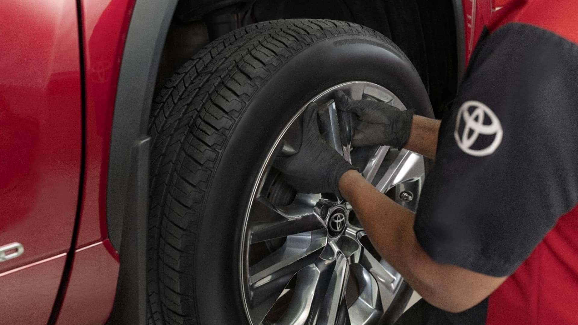 service tech working on tire