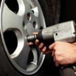 Auto mechanic changing car wheel