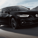 2022 Black Nissan Maxima Driving Swiftly Through the Countryside with Sport Tuned Suspension