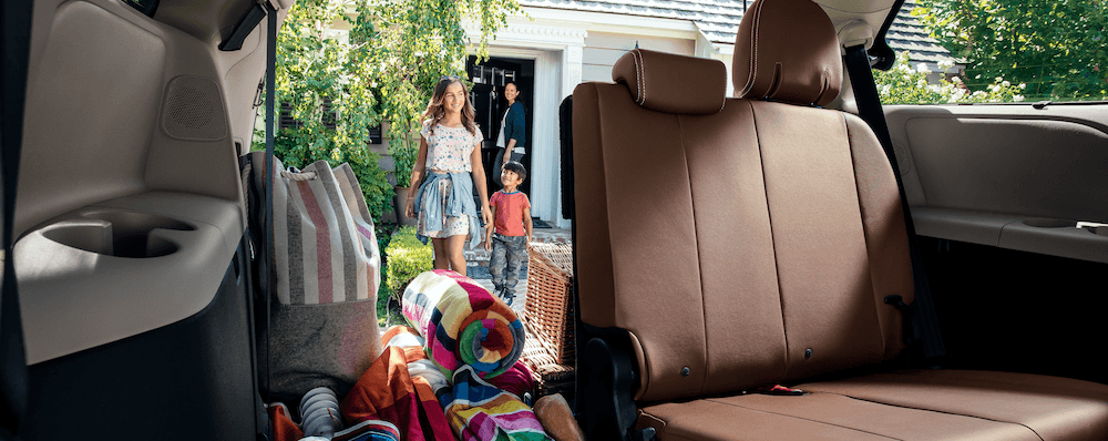 Third row of a Toyota Sienna loaded up with cargo and the liftgate open