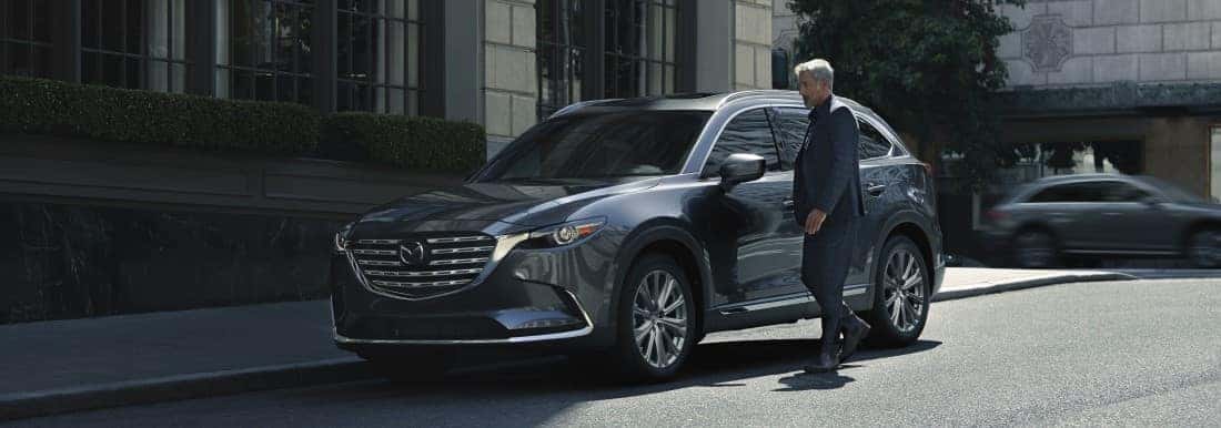 Man next to Mazda CX-9