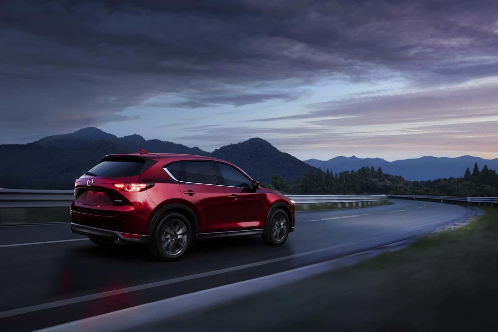 2020 Mazda CX-5 red driving at dusk on rainy scenic highway