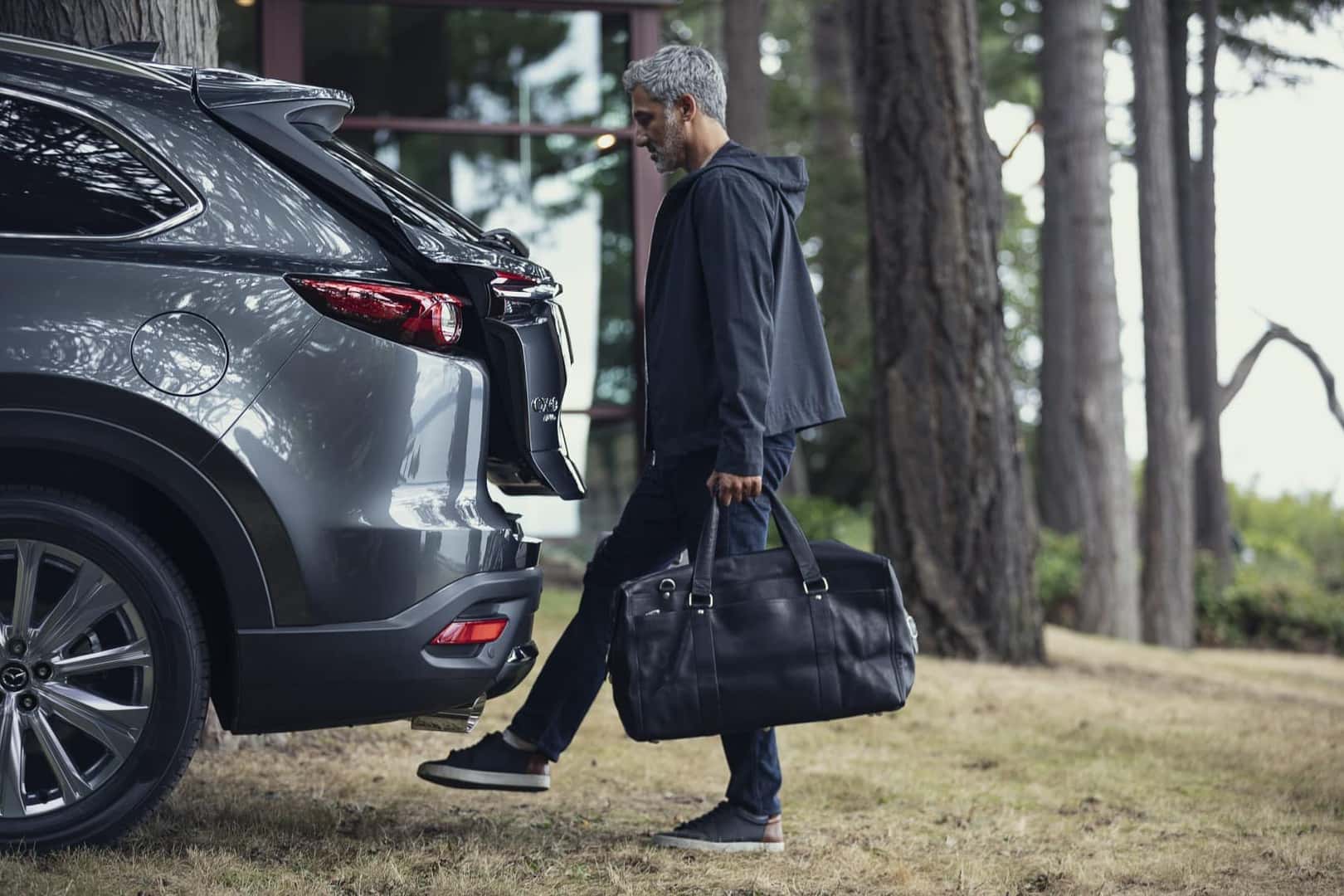 2021 Mazda CX-9 hands free liftgate guy opening rear hatch with foot holding bags