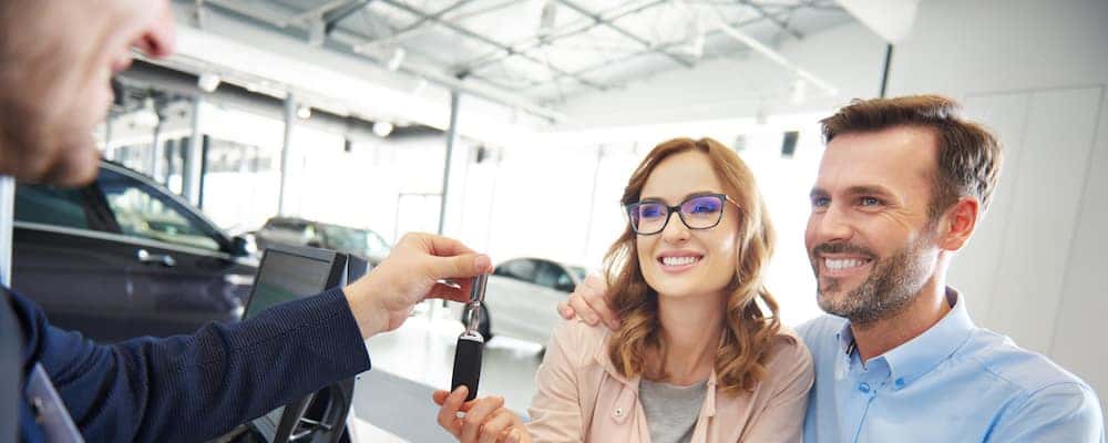 couple being handed keys to new car