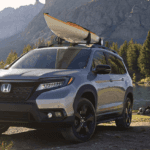 Black 2019 Honda Passport near campsite with canoe