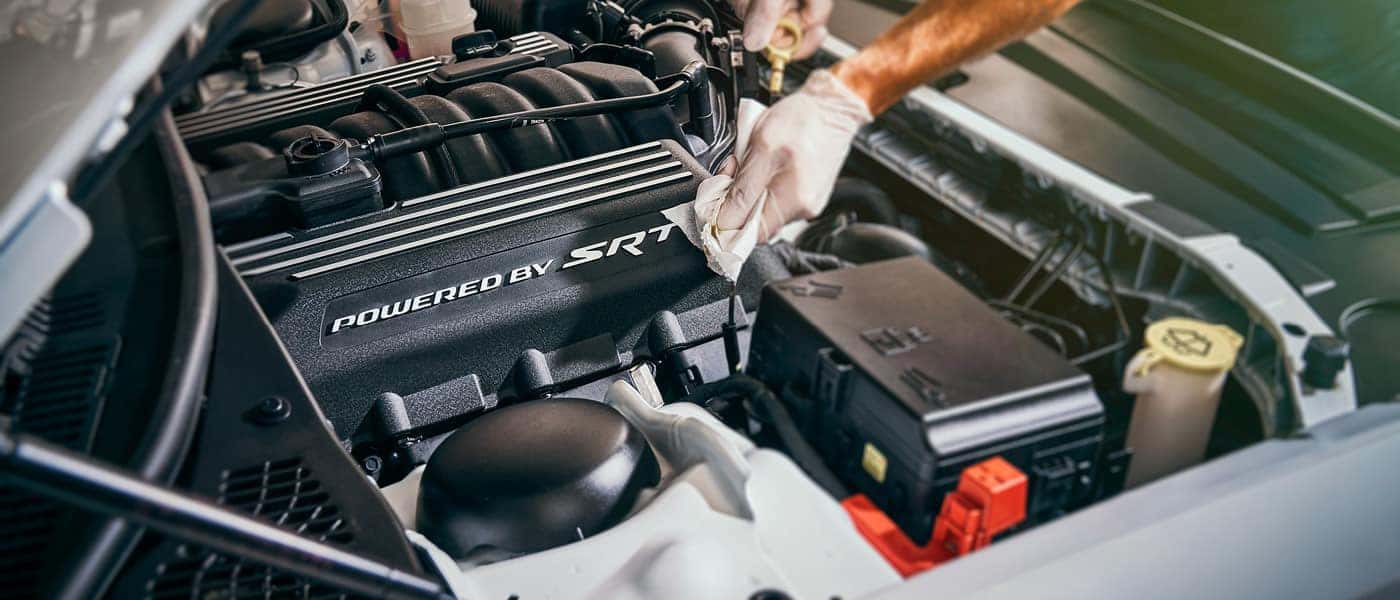 Service department checking oil