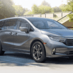2021 Honda Odyssey Elite Trim Level parked in front of neighborhood park