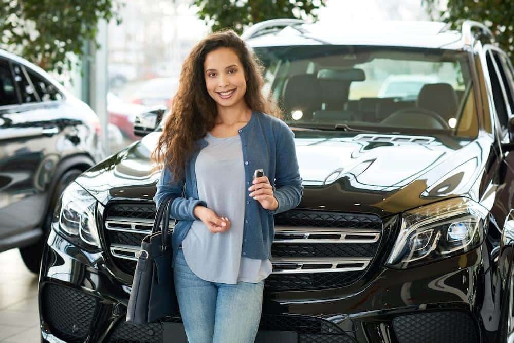 Woman smiling after buying an SUV using vehicle financing