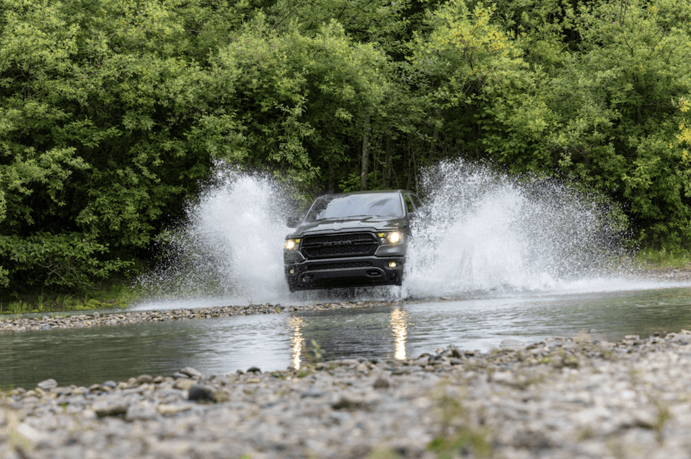 2024 RAM 1500 off-roading through a river of water