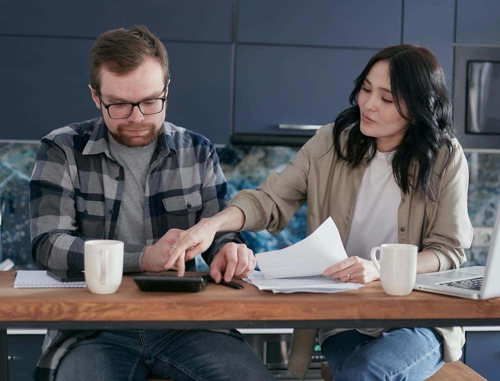 Man and woman budgeting for a car loan or lease