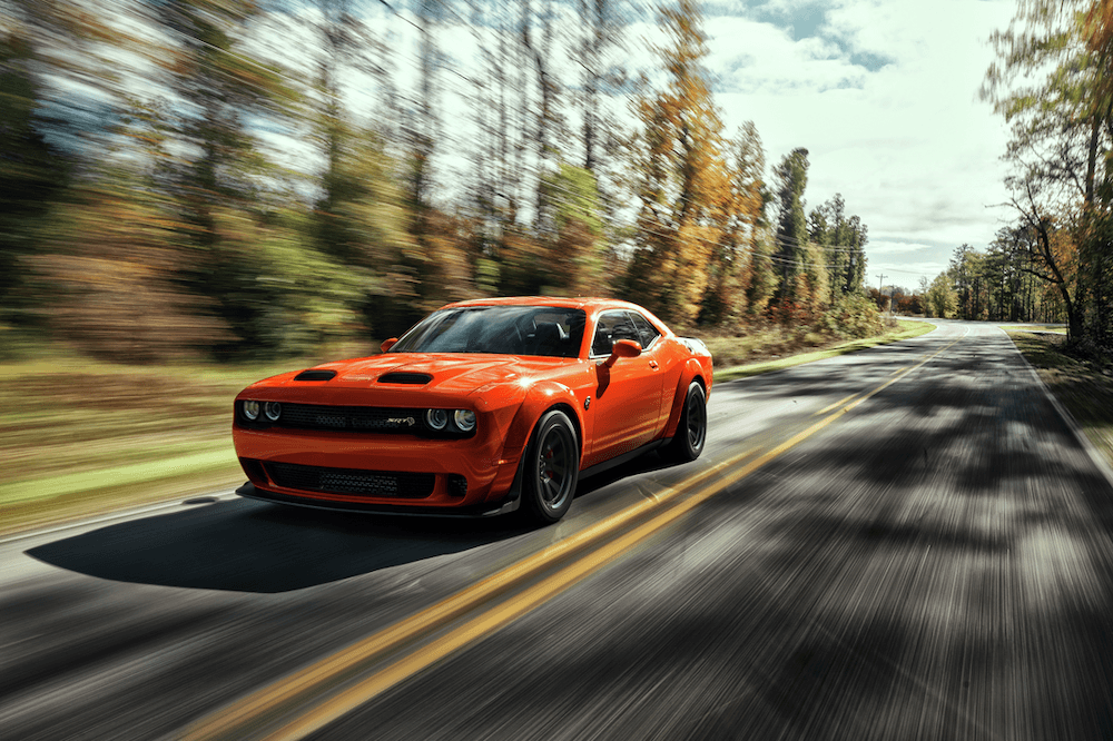 2023 Challenger SRT Hellcat Redeye Widebody in Sinamon Stick driving along a tree lined road