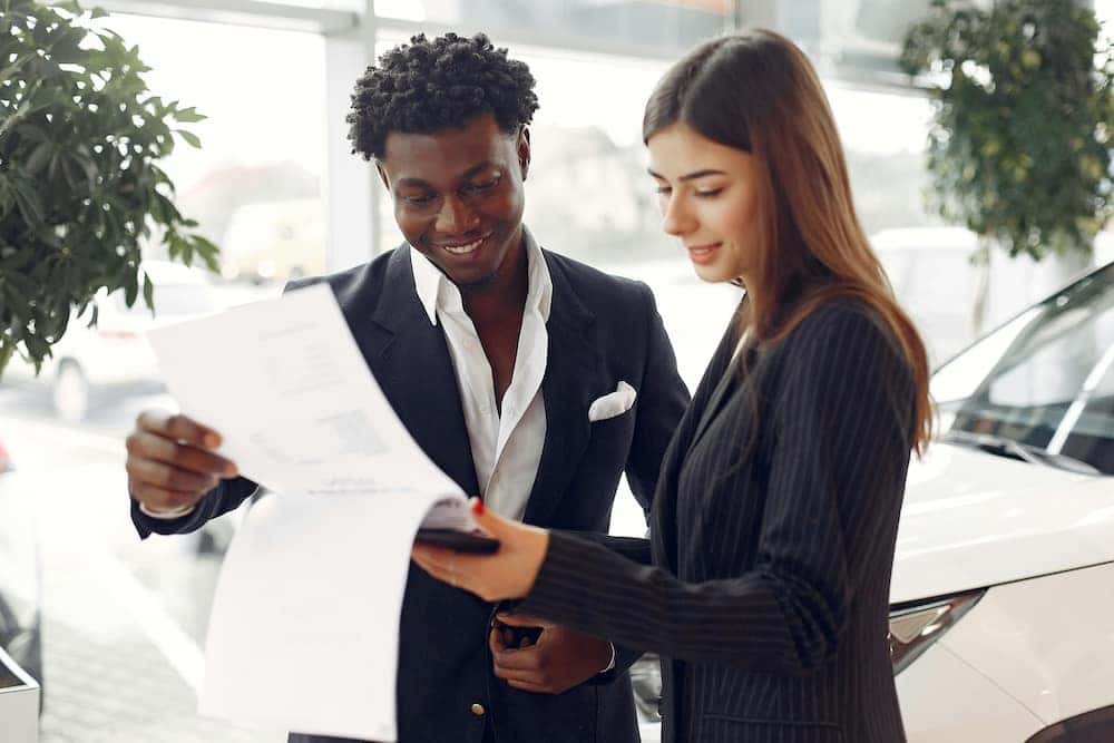 Sales Advocate sharing details of incentives with a man who wants to buy a car in person