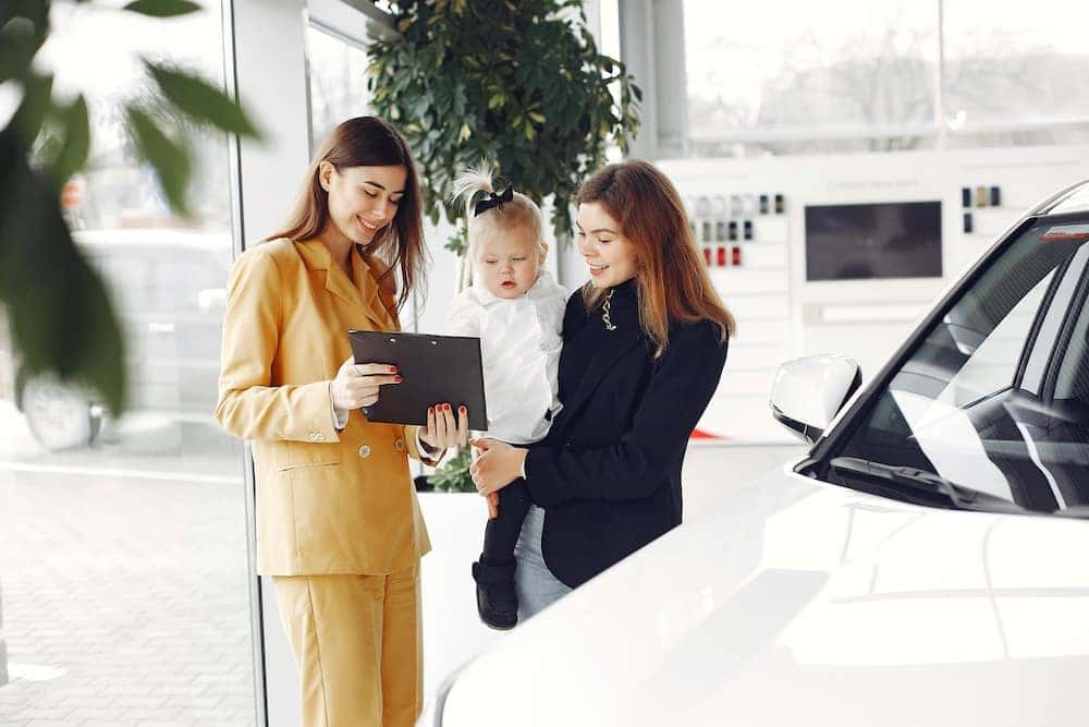 Sales Advocate selling a car to a woman who's car shopping in person
