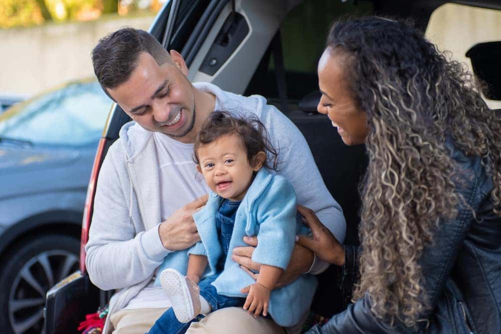 Family with baby car shopping for the best family SUV