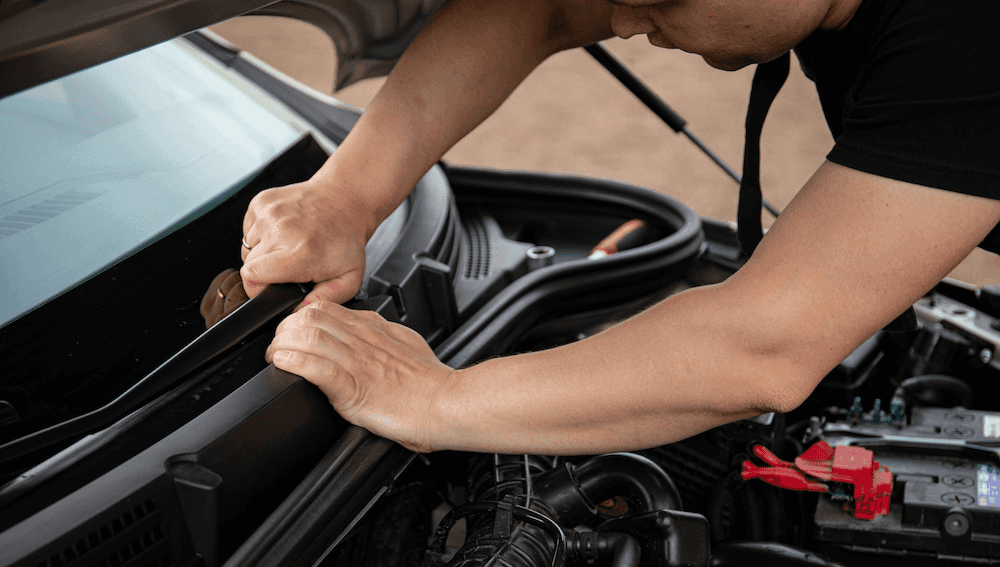Auto service technician inspecting a vehicle