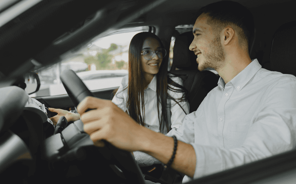 Man and woman taking a used car for a test drive in Richmond, VA