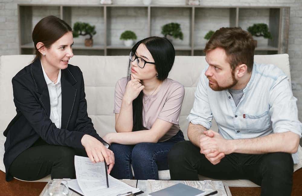 Man and woman reviewing paperwork at a car dealership in Richmond, VA